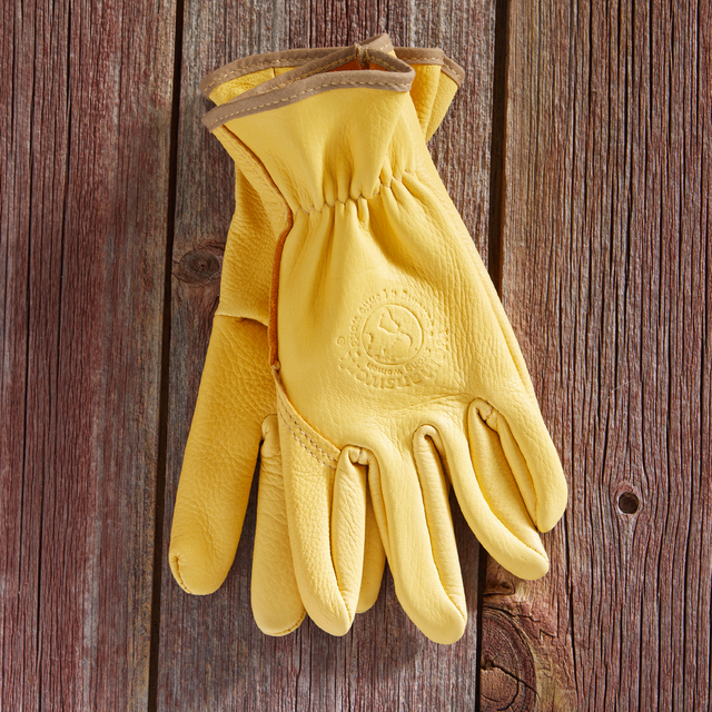 Yellow work glove on a wooden surface