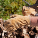 Pair of brown  womans work gloves against a blurred natural background